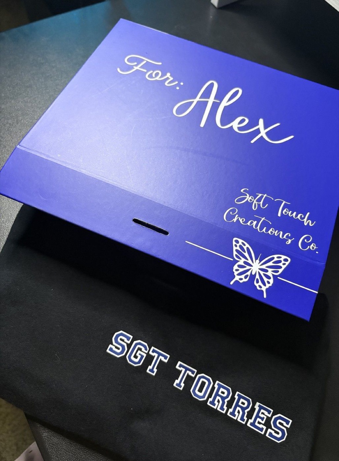 Personalized Soft Touch Creations gift box beside a custom SGT Torres shirt